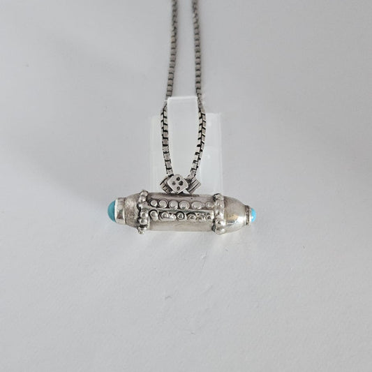 Silver necklace with a pendant on a white background
